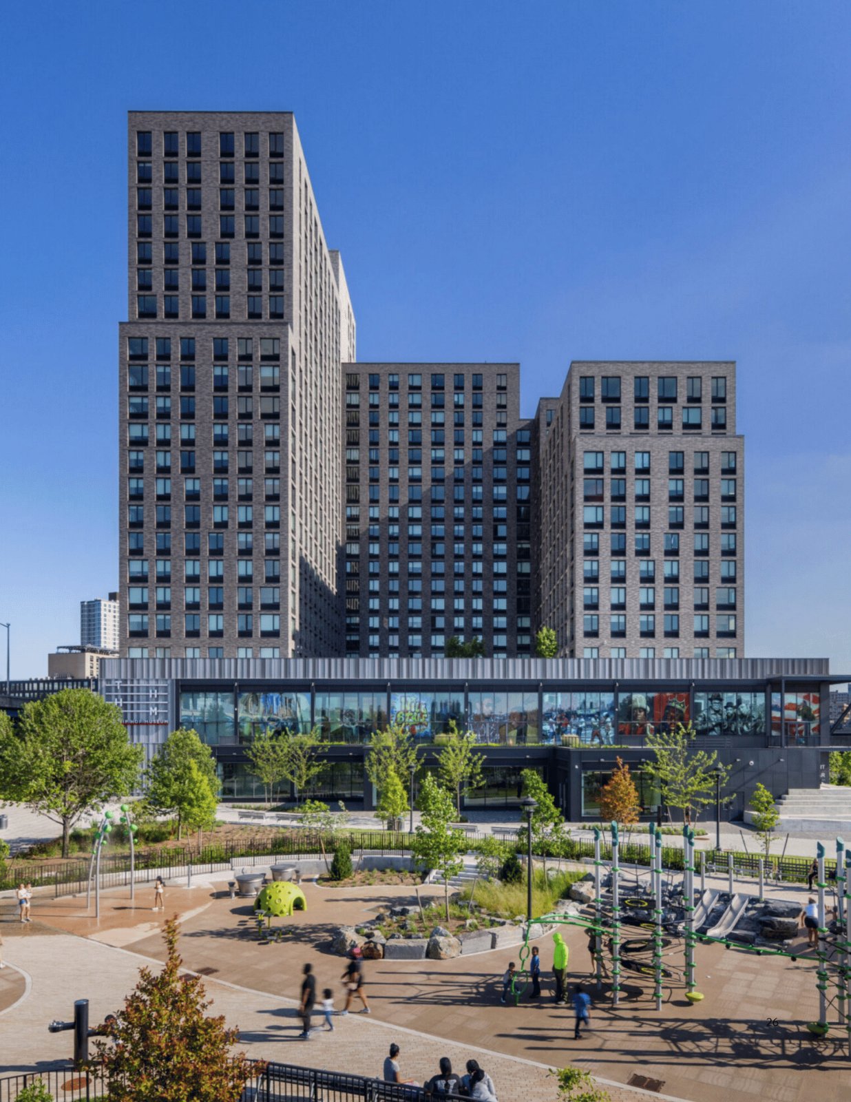High-rise buildings above a landscaped public plaza at the Bronx Point development in the South Bronx, New York.